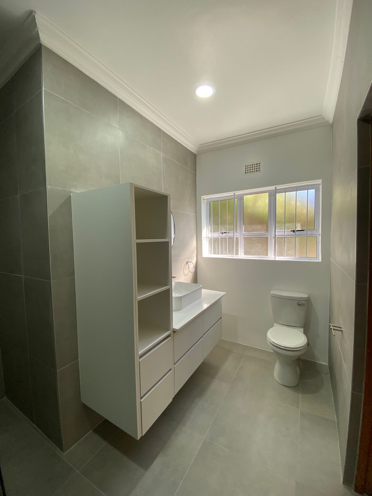 Modern grey tiled bathroom